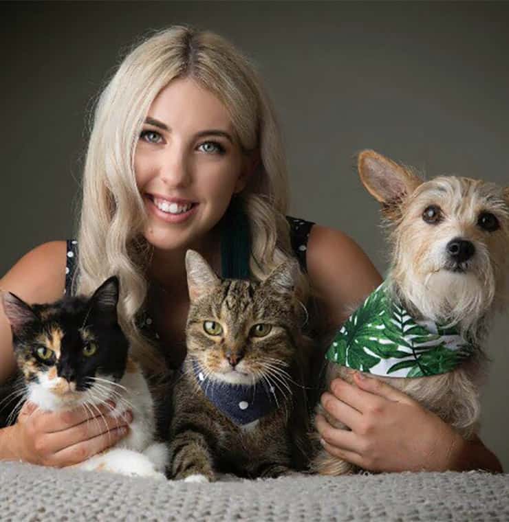 Mykeala holding her dog and cats